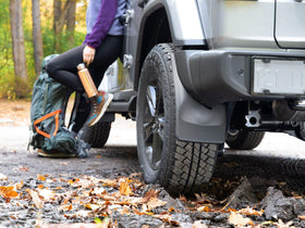 WeatherTech mudflap mounted in wheelwell illustrating no-drill fit and coverage
