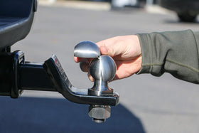 Weigh Safe clamshell beside ruler illustrating compact size and easy portability