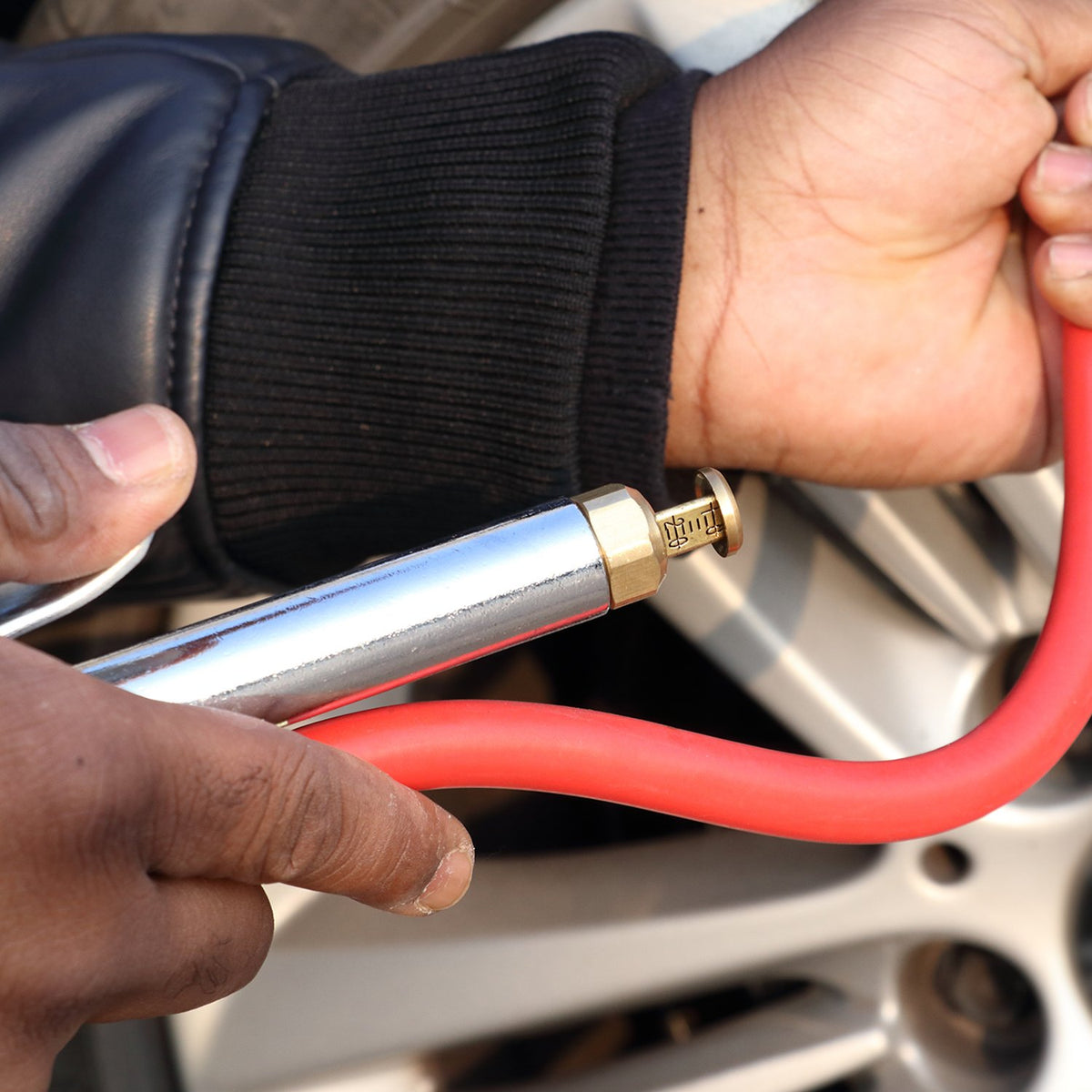 WYNNsky inflator in use on a car tire illustrating easy access and accurate inflation