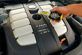 Garage lifestyle shot with XADO bottle and tools indicating DIY convenience