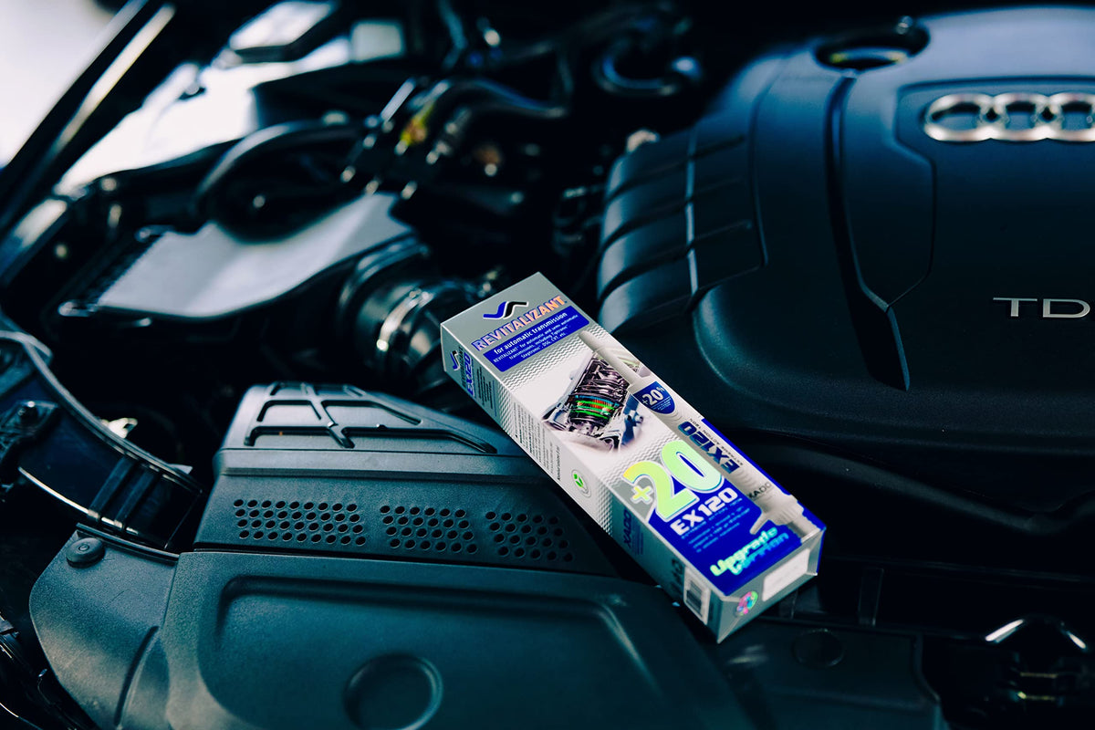 Mechanic in garage using XADO during service, restores gearbox reliability