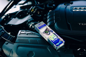 Mechanic in garage using XADO during service, restores gearbox reliability