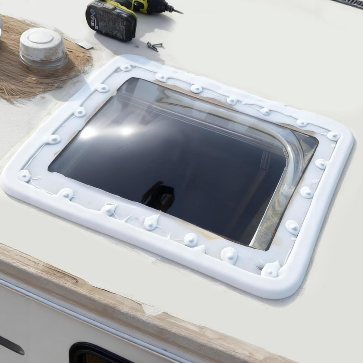 XMK skylight next to ladder showing scale and lightweight handling benefit