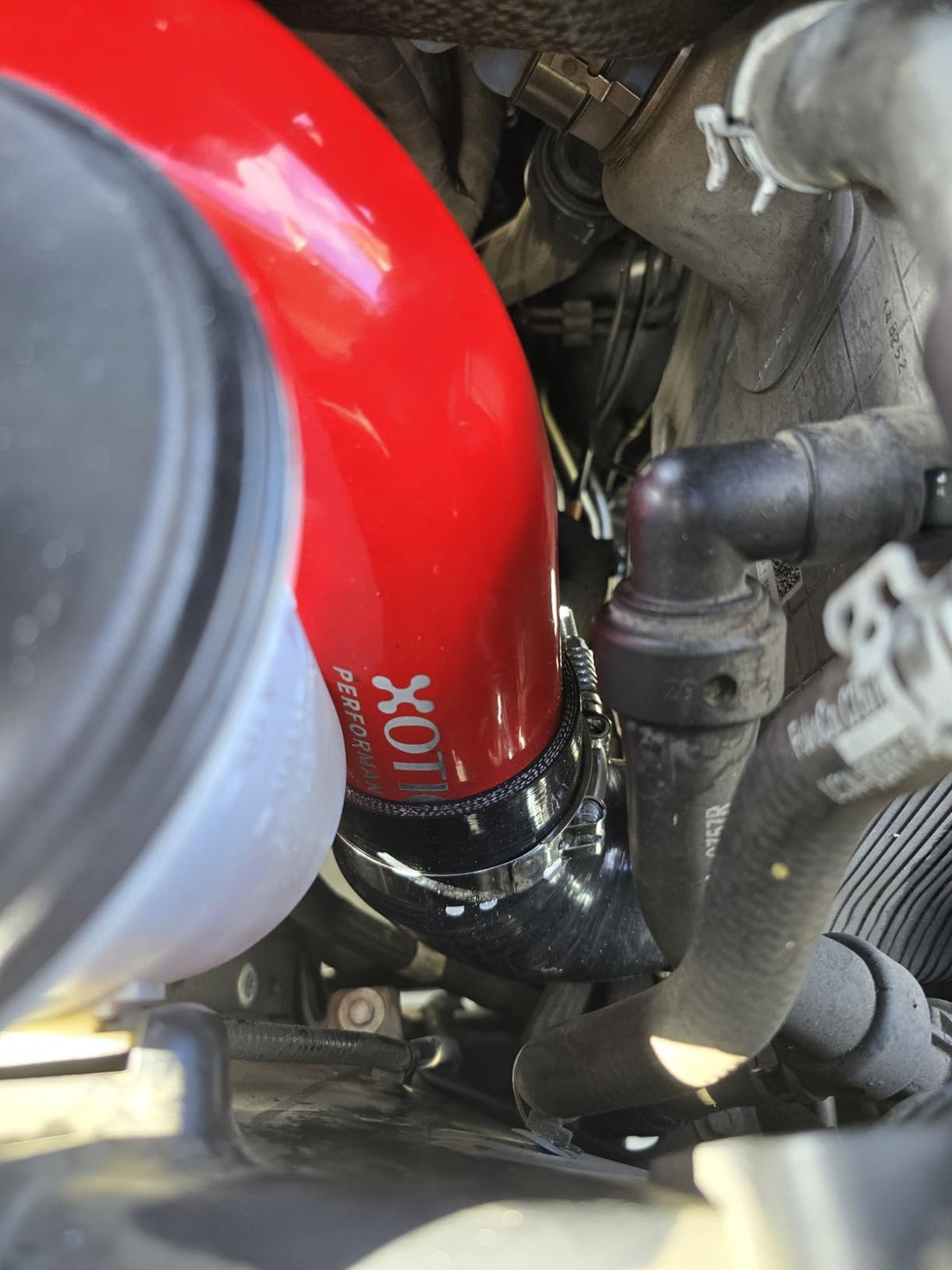 Xotic Performance stainless spring-loaded T-bolt clamp close-up ensuring tight seal