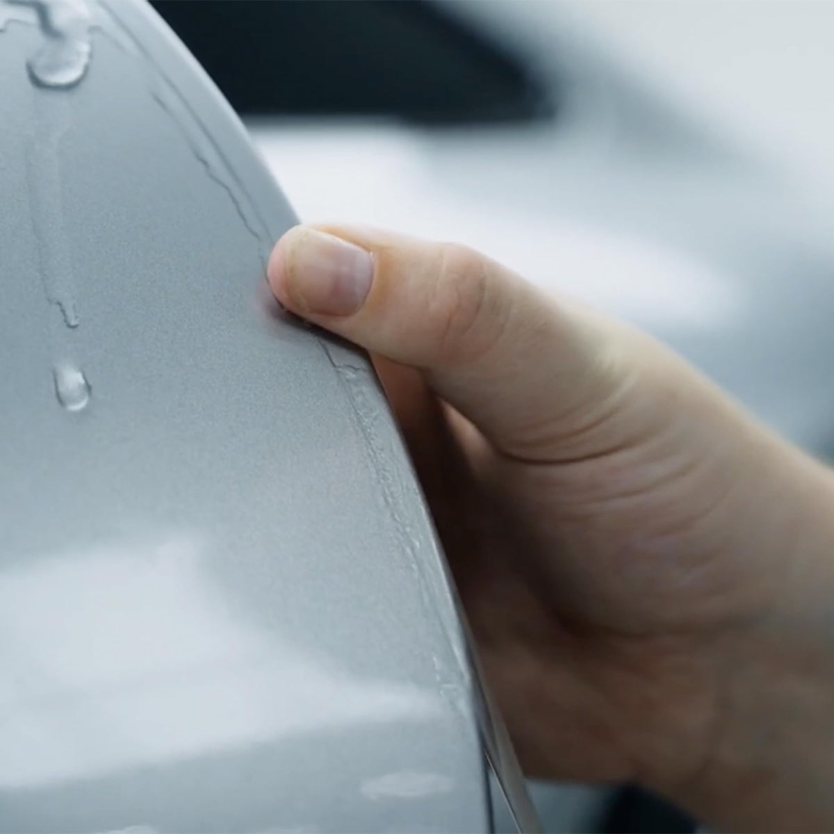 XPEL demonstrating self-healing film smoothing minor scratches benefit