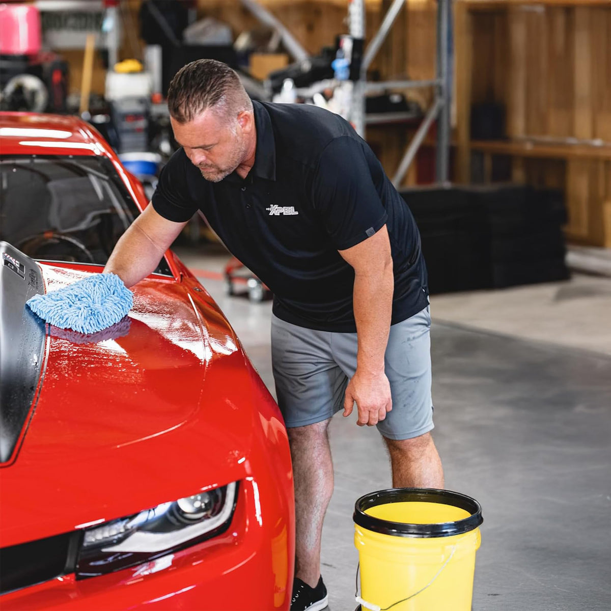 XPEL wash solution being applied to a car showing paint-safe cleaning benefit