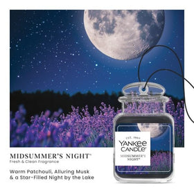 Yankee Candle Car Jar hanging from rearview mirror freshening cabin air