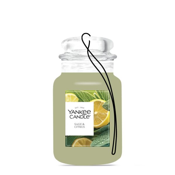 Hanging Yankee Candle Car Jar on a rearview mirror providing continuous odor neutralizing benefit