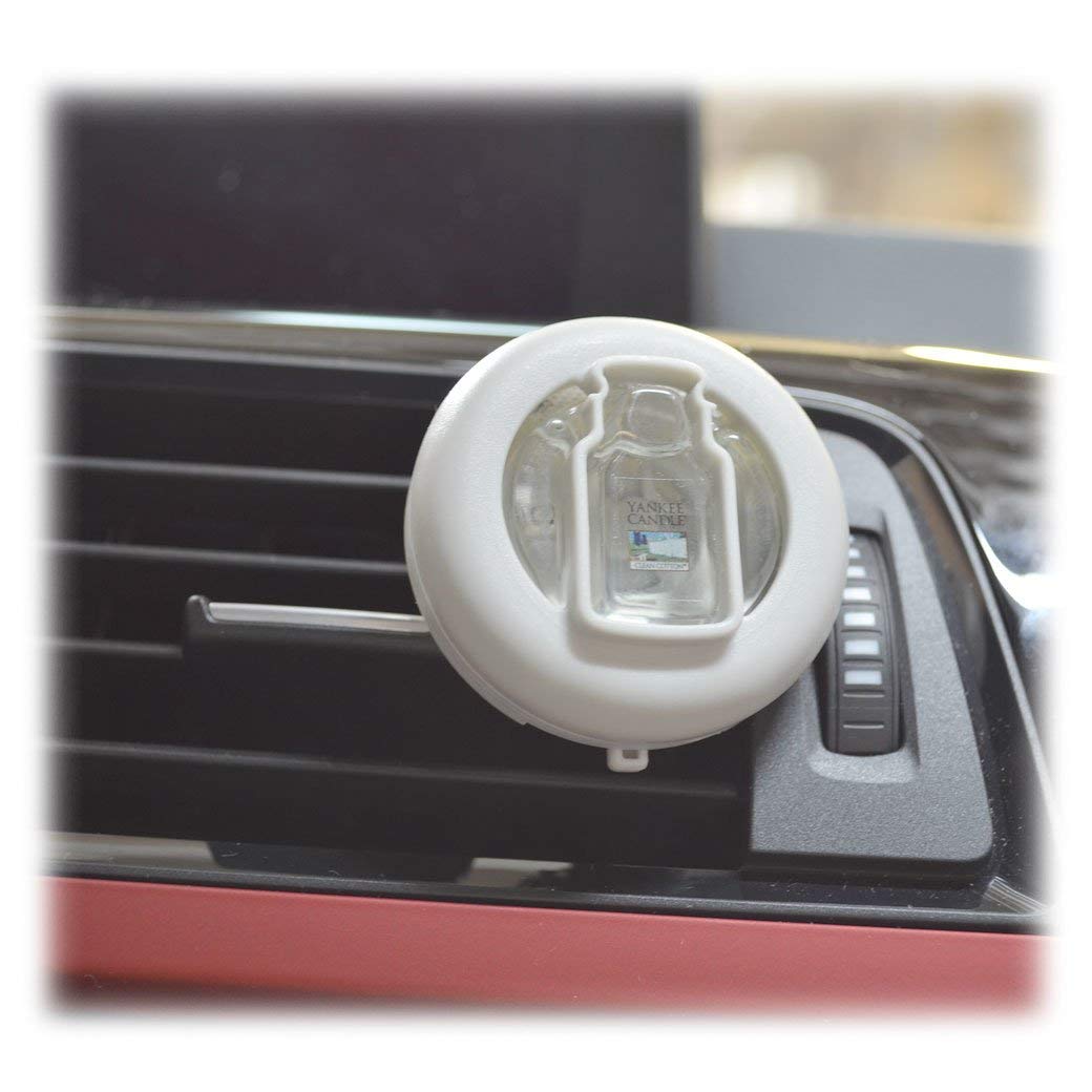Yankee Candle vent clip beside car keys showing compact size for easy placement