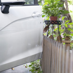 YIJINSHENG installed on car door edge demonstrating paint protection