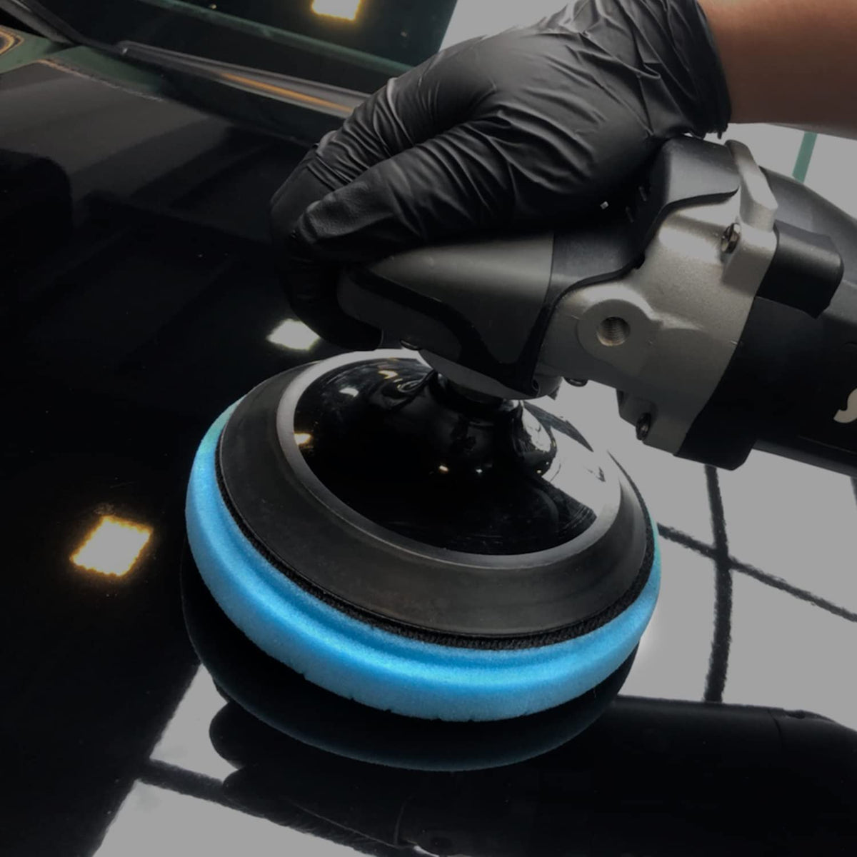 ZFE pad held in hand for size comparison showing compact 6-inch diameter and ergonomic handling